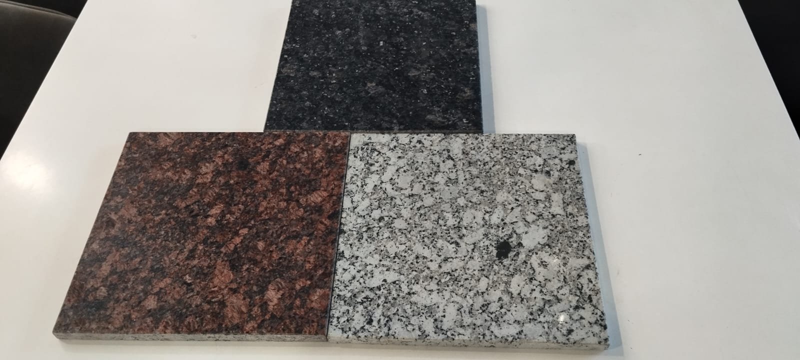 Black, tan brown and white granite samples for modular kitchen countertops in Morigaon